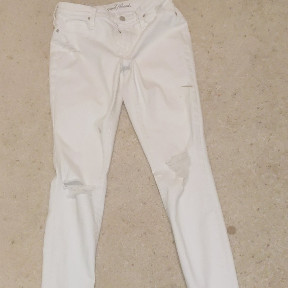 A pair of white ripped jeans